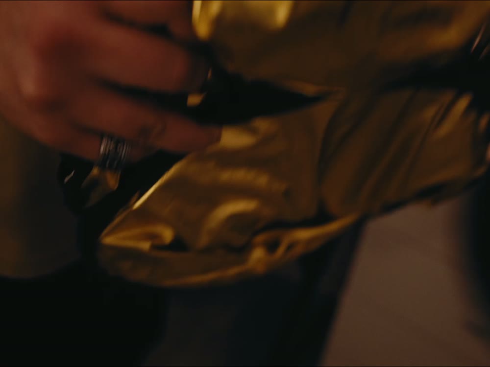 Hands unfolding a gold reflector