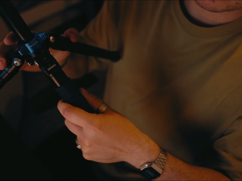 Hands assembling a light stand